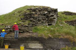 South Howe broch being cleaned -the faced entrance passage is on the right