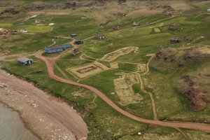 Photograph of the Norse ruins and the modern settlement of Qassiarsuk