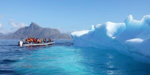 Photo of a power boat and an iceberg