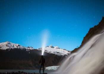 Photo of a man wearing a head torch in the mountains
