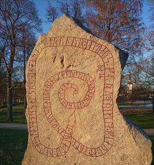 Photo of a stone with runes in the shape of a snake